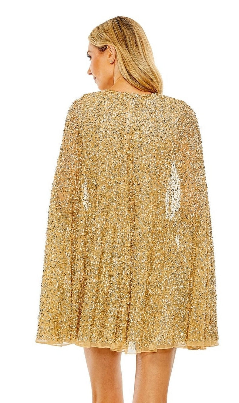 A woman with blonde hair is shown from the back wearing the Mac Duggal 5931 short gold beaded cocktail dress featuring an elegant cape-sleeve design.